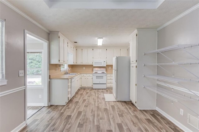 1980 Mcconnell Rd, Grayson, GA 30017 - kitchen featuring white appliances, a sink, light countertops, light wood-type flooring, and a textured ceiling