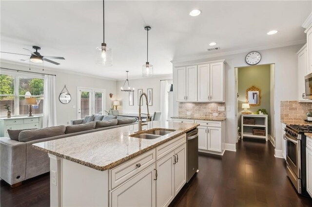4020 Huron Dr, Cumming, GA 30028 - kitchen featuring appliances with stainless steel finishes, ceiling fan, dark wood finished floors, pendant lighting, and white cabinetry