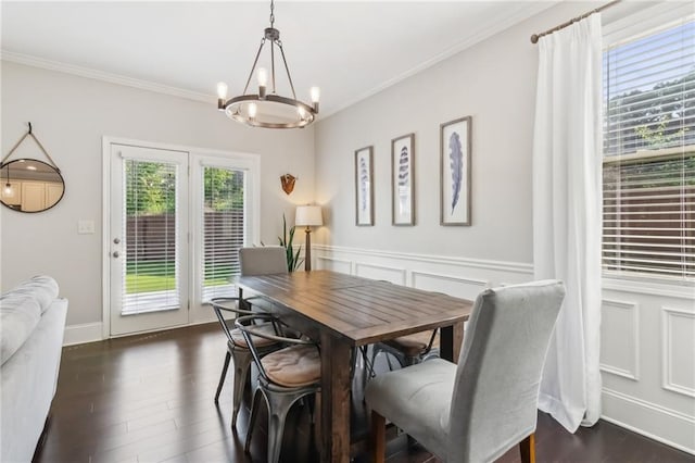 4020 Huron Dr, Cumming, GA 30028 - dining space with a chandelier, crown molding, a wainscoted wall, dark wood finished floors, and a decorative wall