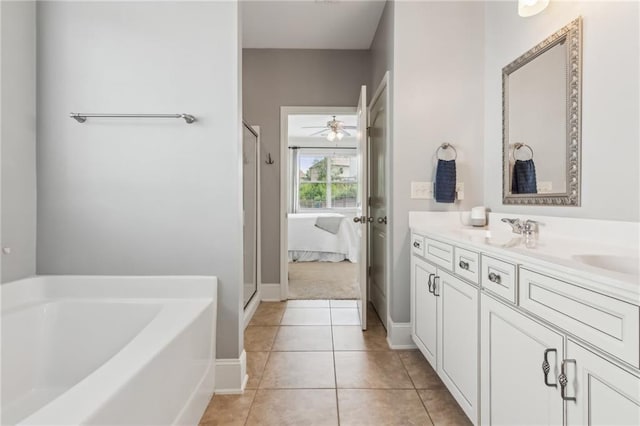 4020 Huron Dr, Cumming, GA 30028 - bathroom featuring a garden tub, double vanity, ceiling fan, a stall shower, and tile patterned floors