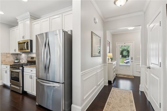 4020 Huron Dr, Cumming, GA 30028 - kitchen featuring stainless steel appliances, dark wood-style floors, ornamental molding, white cabinets, and tasteful backsplash