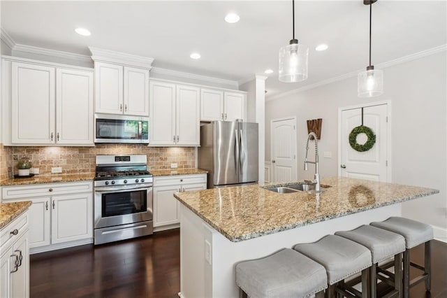 4020 Huron Dr, Cumming, GA 30028 - kitchen featuring stainless steel appliances, crown molding, backsplash, white cabinets, and dark wood finished floors