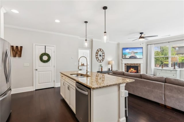 4020 Huron Dr, Cumming, GA 30028 - kitchen with stainless steel appliances, a ceiling fan, dark wood-style flooring, pendant lighting, and light stone counters
