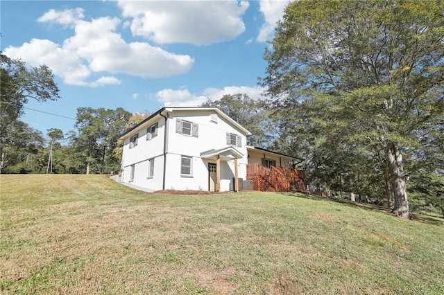 view of side of home with a yard