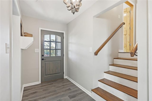 doorway to outside featuring a chandelier and dark wood-type flooring