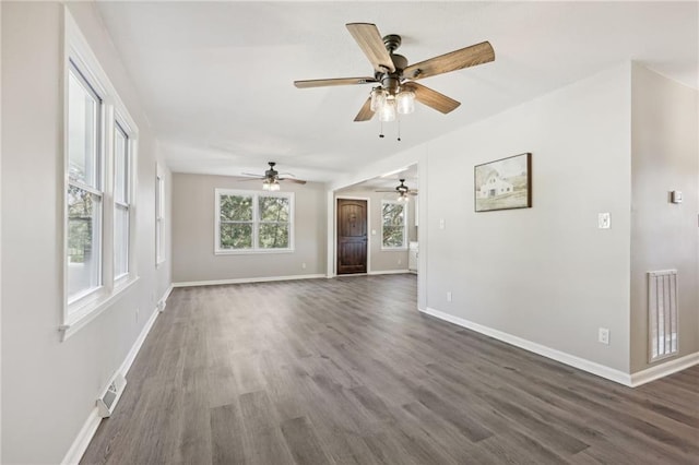 unfurnished living room with dark hardwood / wood-style flooring