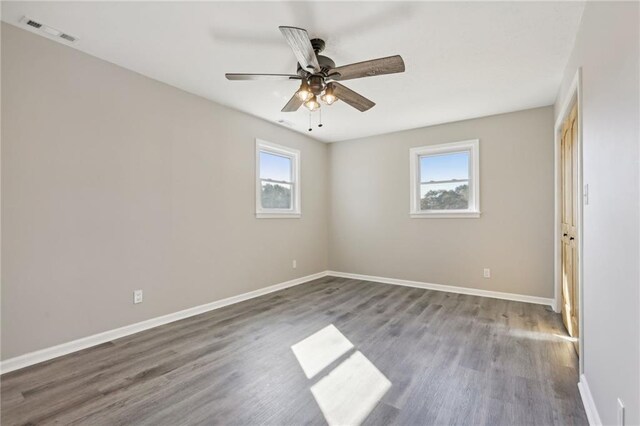 empty room featuring hardwood / wood-style flooring and ceiling fan