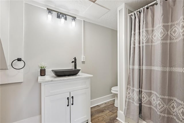 bathroom with hardwood / wood-style floors, toilet, and vanity