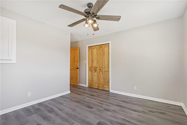 empty room featuring ceiling fan and dark hardwood / wood-style floors