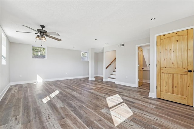 unfurnished living room with hardwood / wood-style flooring and ceiling fan