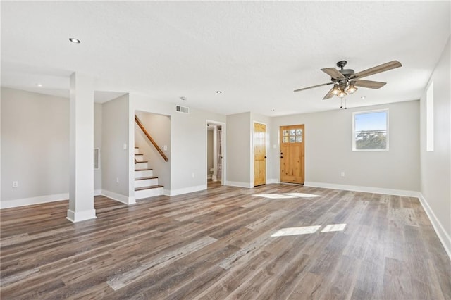 unfurnished living room featuring ceiling fan and wood-type flooring