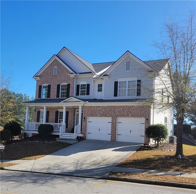 view of front of property featuring cooling unit, covered porch, and a garage