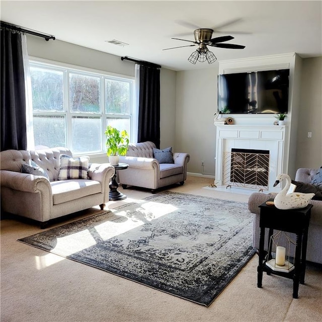 carpeted living room featuring ceiling fan