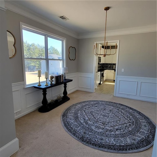 interior space featuring light colored carpet and ornamental molding