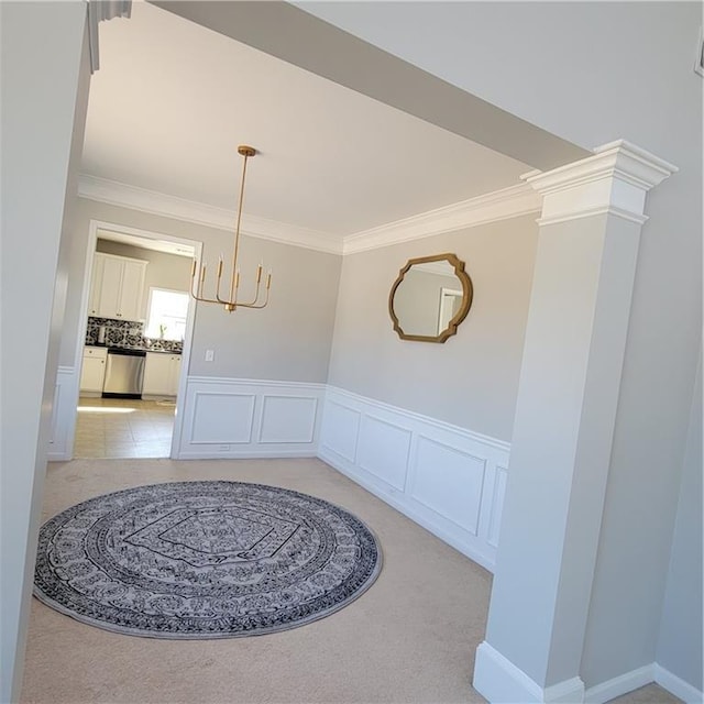 dining room featuring light colored carpet and crown molding