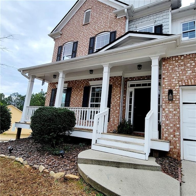 entrance to property featuring covered porch