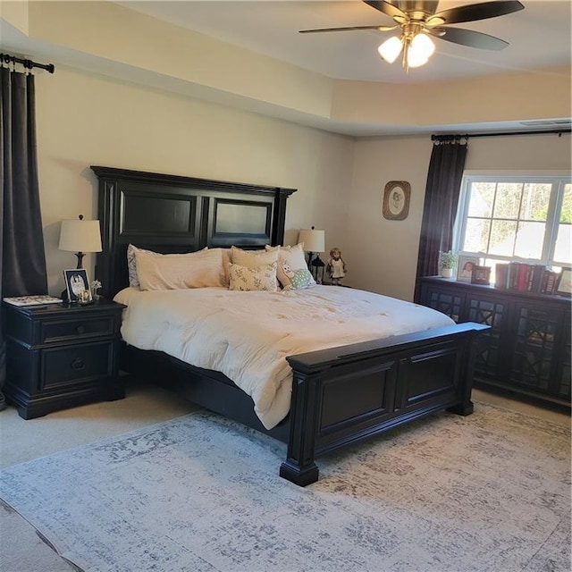 bedroom featuring light colored carpet and ceiling fan