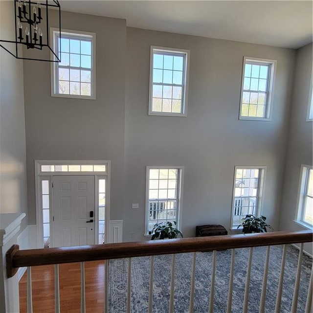 foyer featuring a chandelier, hardwood / wood-style floors, and a wealth of natural light