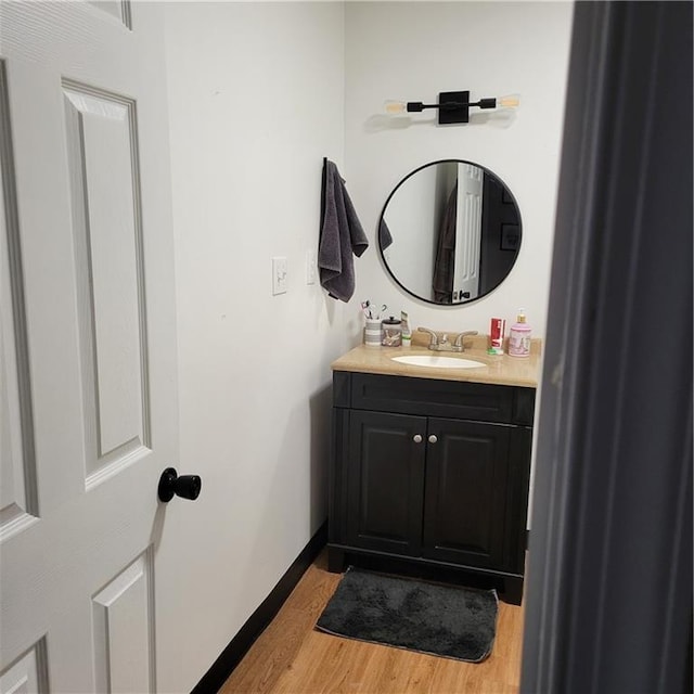 bathroom with hardwood / wood-style floors and vanity