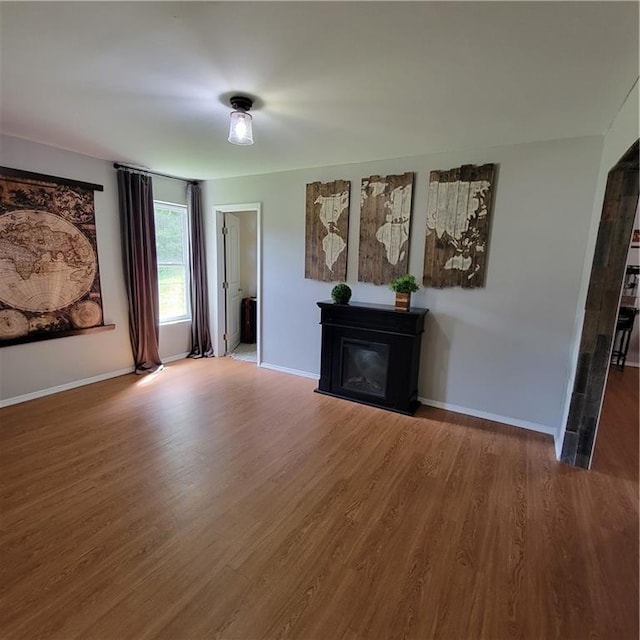 unfurnished living room featuring hardwood / wood-style flooring