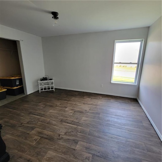 unfurnished room with dark hardwood / wood-style floors