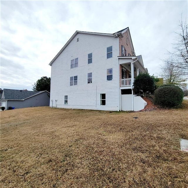 view of property exterior featuring a lawn