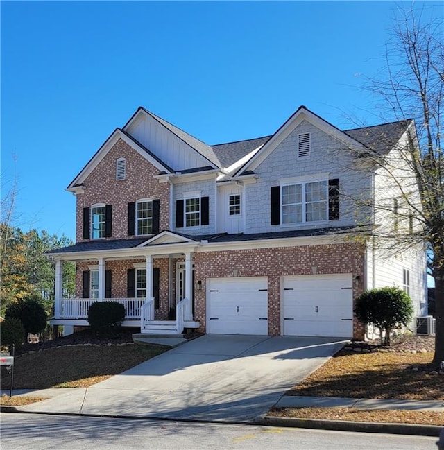 view of front of property with covered porch, a garage, and central air condition unit