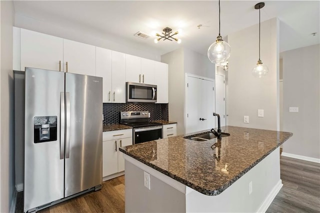 898 Oak St SW Unit 3228, Atlanta, GA 30310 - kitchen featuring appliances with stainless steel finishes, dark wood finished floors, white cabinets, and decorative backsplash