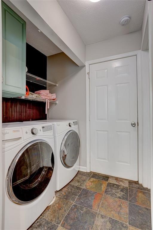 bathroom featuring a textured ceiling and toilet