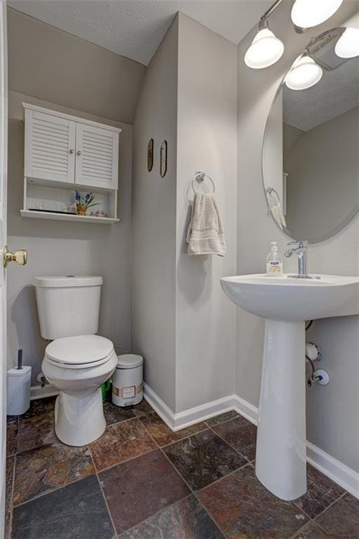 bathroom with vanity, toilet, and walk in shower