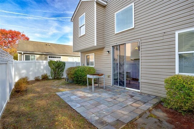 rear view of property featuring a patio area and central AC unit