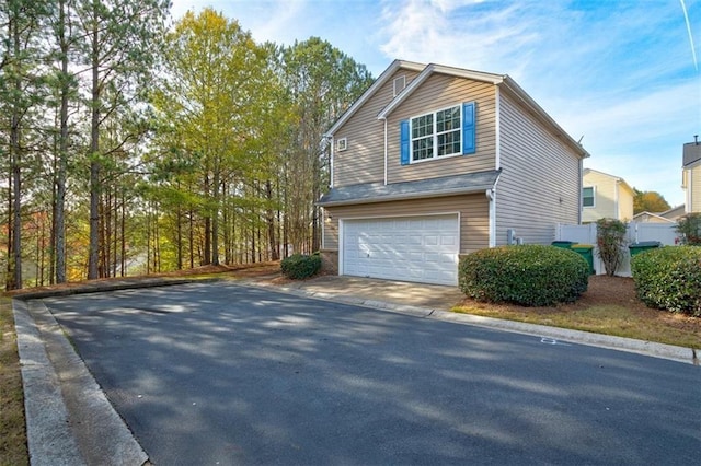 view of side of property with a garage