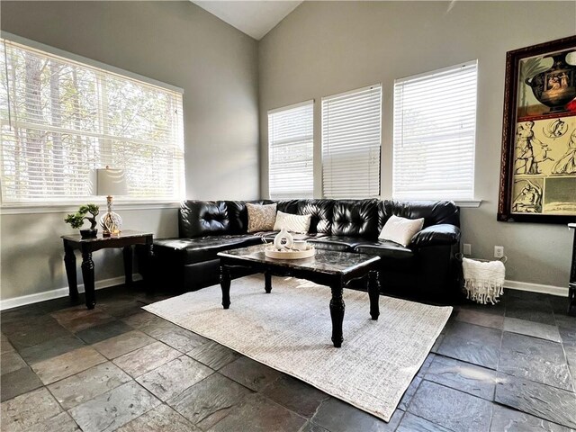 living room featuring ceiling fan and high vaulted ceiling