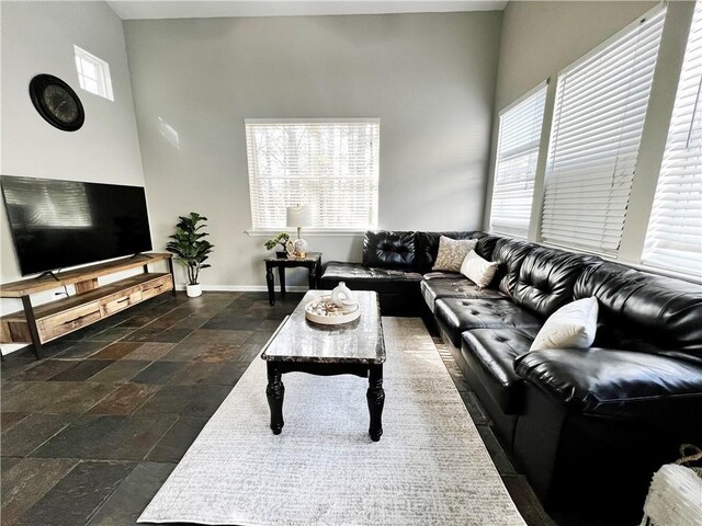 living room with high vaulted ceiling, plenty of natural light, and ceiling fan