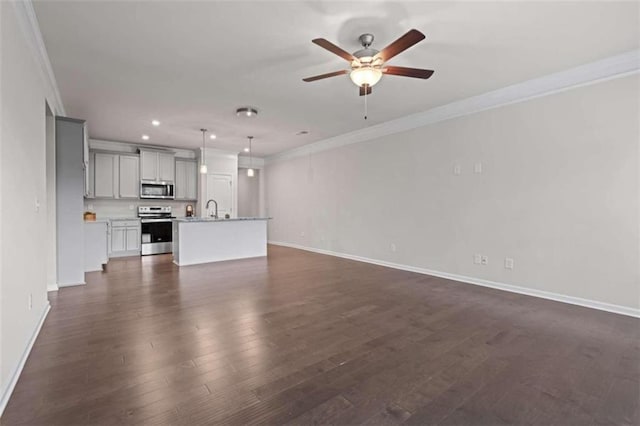 unfurnished living room featuring sink, ceiling fan, crown molding, and dark wood-type flooring