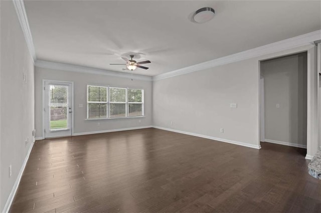 empty room featuring dark wood-type flooring, ceiling fan, and ornamental molding