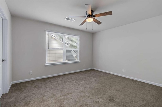 carpeted spare room with ceiling fan