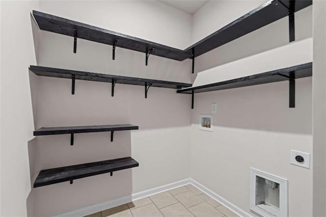 laundry room with hookup for an electric dryer, washer hookup, and light tile patterned floors