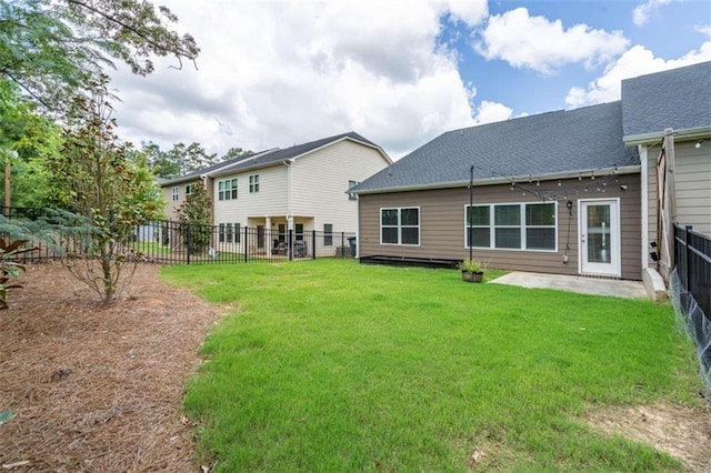 back of house featuring a patio and a lawn