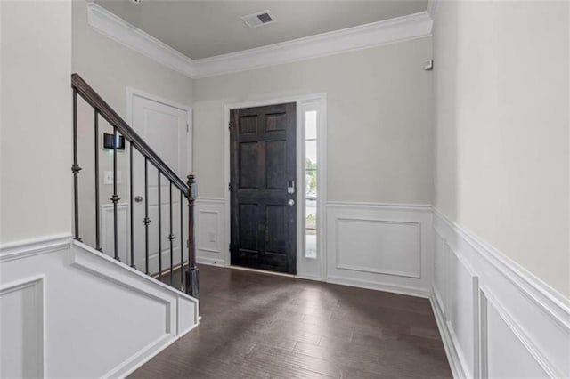 foyer entrance featuring crown molding and dark wood-type flooring