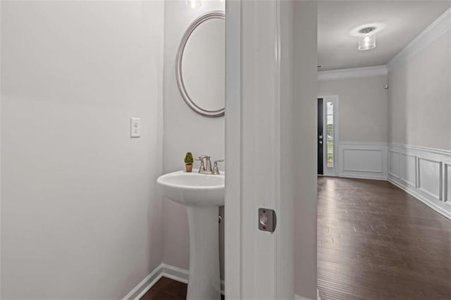 bathroom with crown molding and wood-type flooring