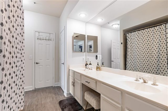 3777 Peachtree Rd NE Unit 1326, Atlanta, GA 30319 - bathroom featuring double vanity, wood finished floors, curtained shower, and recessed lighting