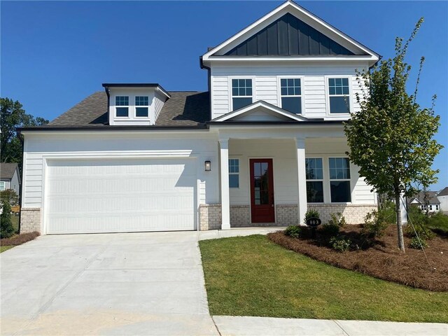 803 Levi Farms Ln, Canton, GA 30115 - craftsman house with driveway, a garage, covered porch, board and batten siding, and a front yard