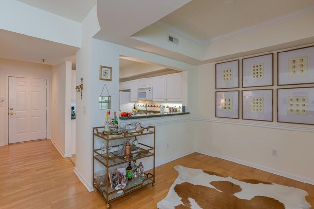 3636 Habersham Rd Unit 2307, Atlanta, GA 30305 - interior space with crown molding, baseboards, visible vents, and light wood-style floors
