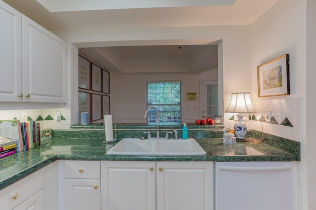 3636 Habersham Rd Unit 2307, Atlanta, GA 30305 - kitchen with a tray ceiling, white dishwasher, a sink, and white cabinetry