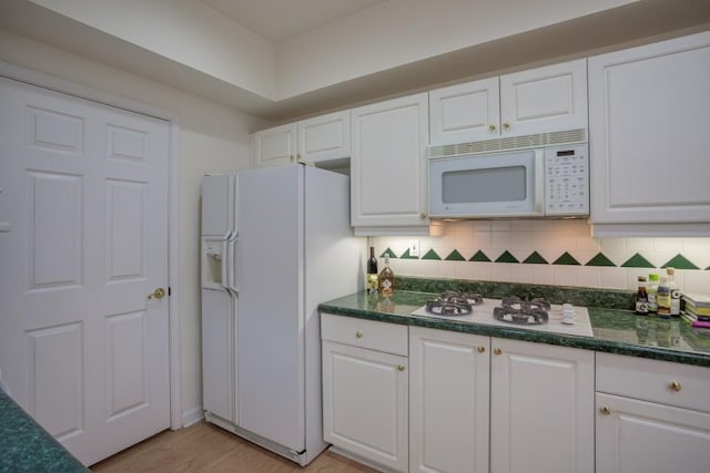 3636 Habersham Rd Unit 2307, Atlanta, GA 30305 - kitchen with white appliances, tasteful backsplash, white cabinetry, and light wood-style floors