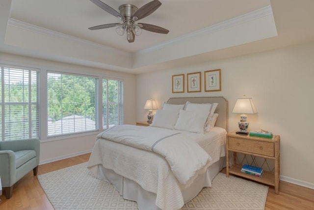 3636 Habersham Rd Unit 2307, Atlanta, GA 30305 - bedroom featuring ornamental molding, a tray ceiling, wood finished floors, and baseboards
