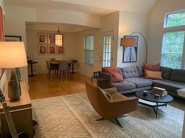 3636 Habersham Rd Unit 2307, Atlanta, GA 30305 - living room featuring lofted ceiling and wood finished floors