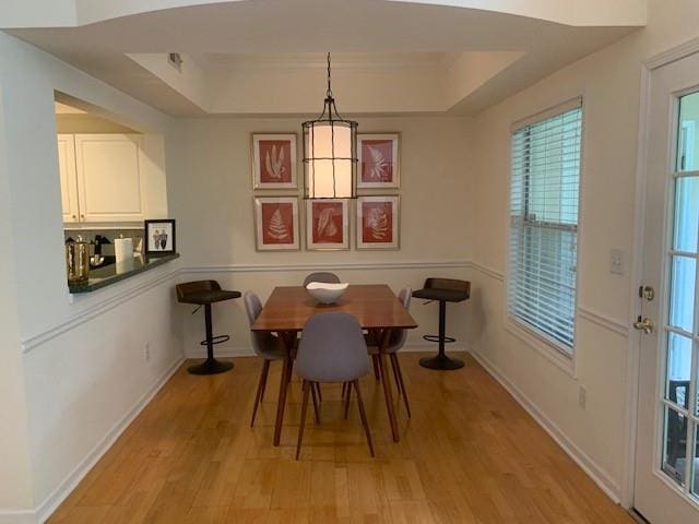 3636 Habersham Rd Unit 2307, Atlanta, GA 30305 - dining room featuring light wood finished floors, a raised ceiling, and baseboards