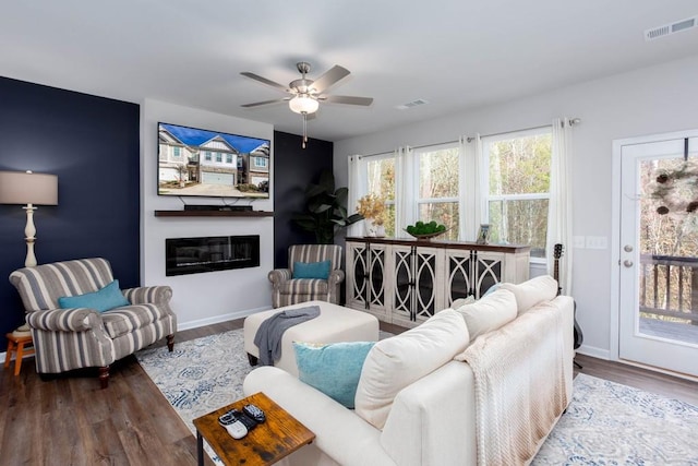 living room featuring hardwood / wood-style floors and ceiling fan